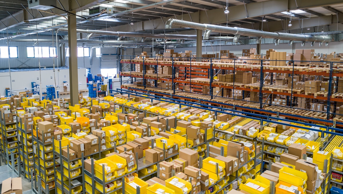 Neatly organized warehouse shelving with labeled boxes in rows