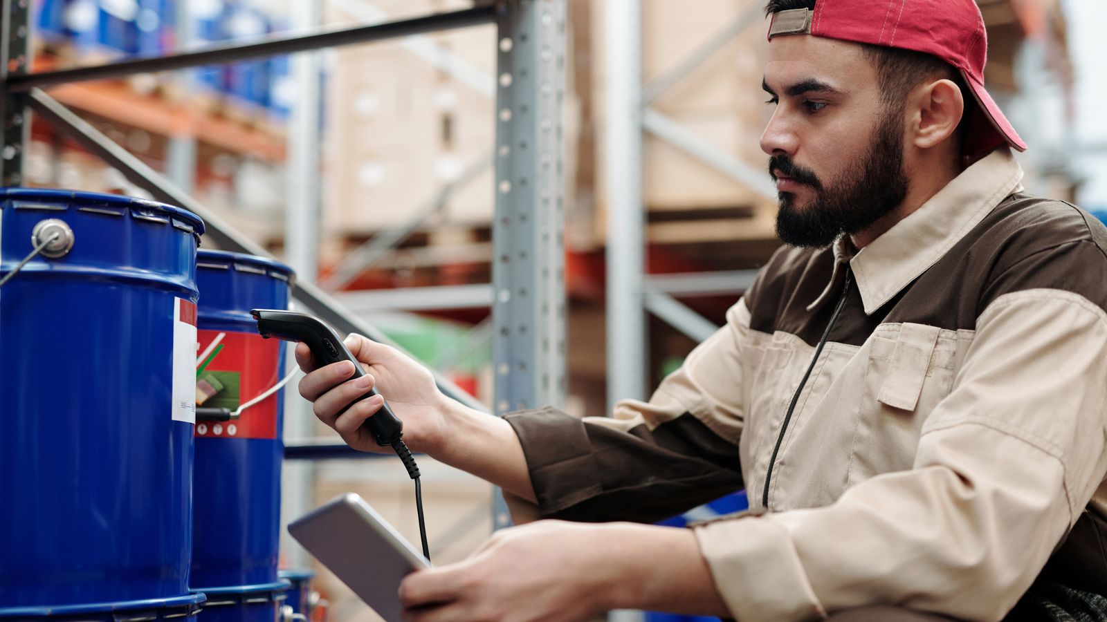 A warehouse worker scanning stock with a handheld device